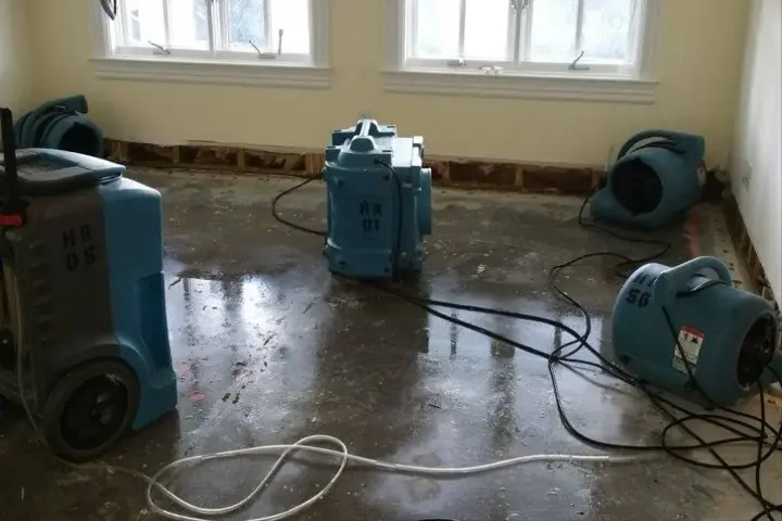 Air movers and a dehumidifier running on a wet floor in a Mount Juliet home