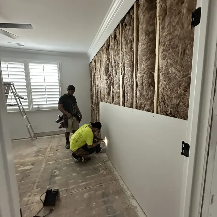 Wet insulation and drywall cut back so the wall cavity can dry