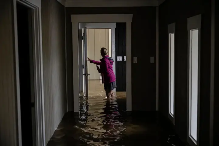 Floodwater standing in a home hallway after heavy rain