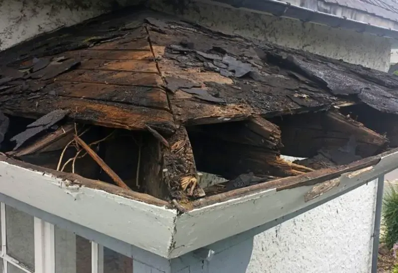 Rotted roof decking and fascia where storm water entered the roof edge